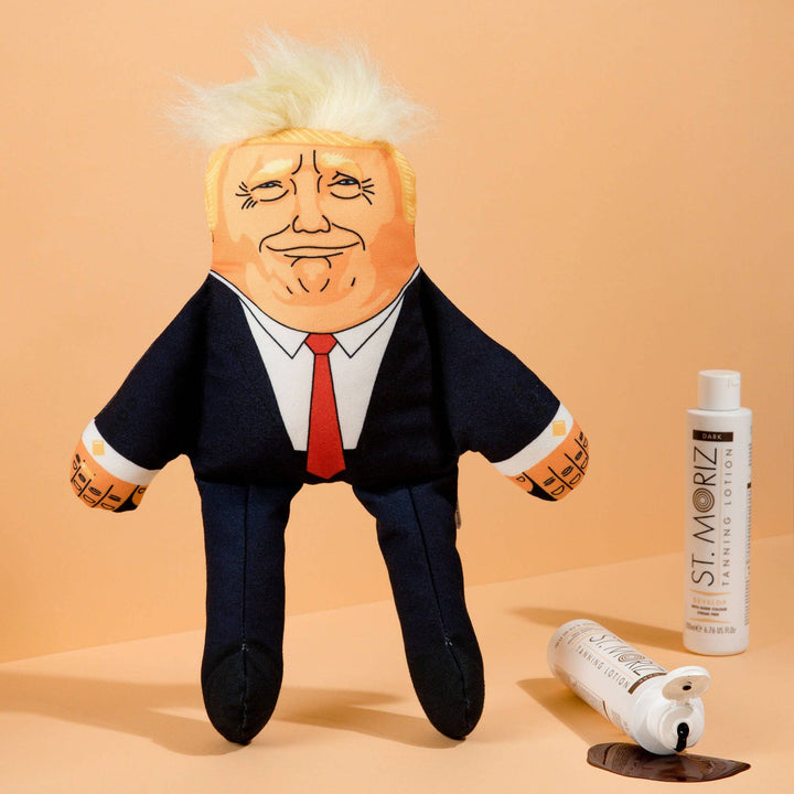 Plush toy resembling a political figure on a beige background with St. Moriz hair care products.
