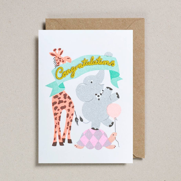 Greeting card with cartoon animals and 'Congratulations' text on a beige background