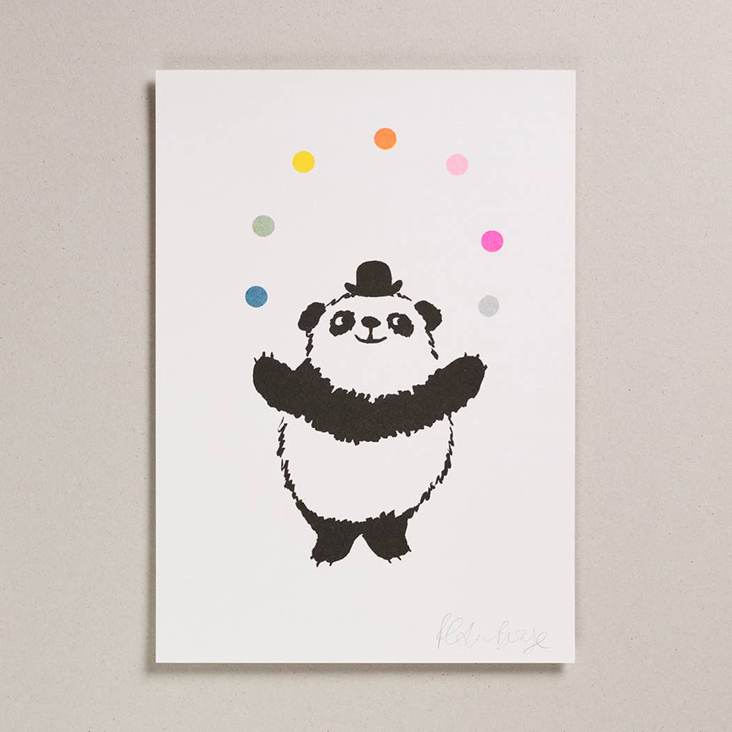 Greetings card picturing a black and white panda juggling colourful balls.
