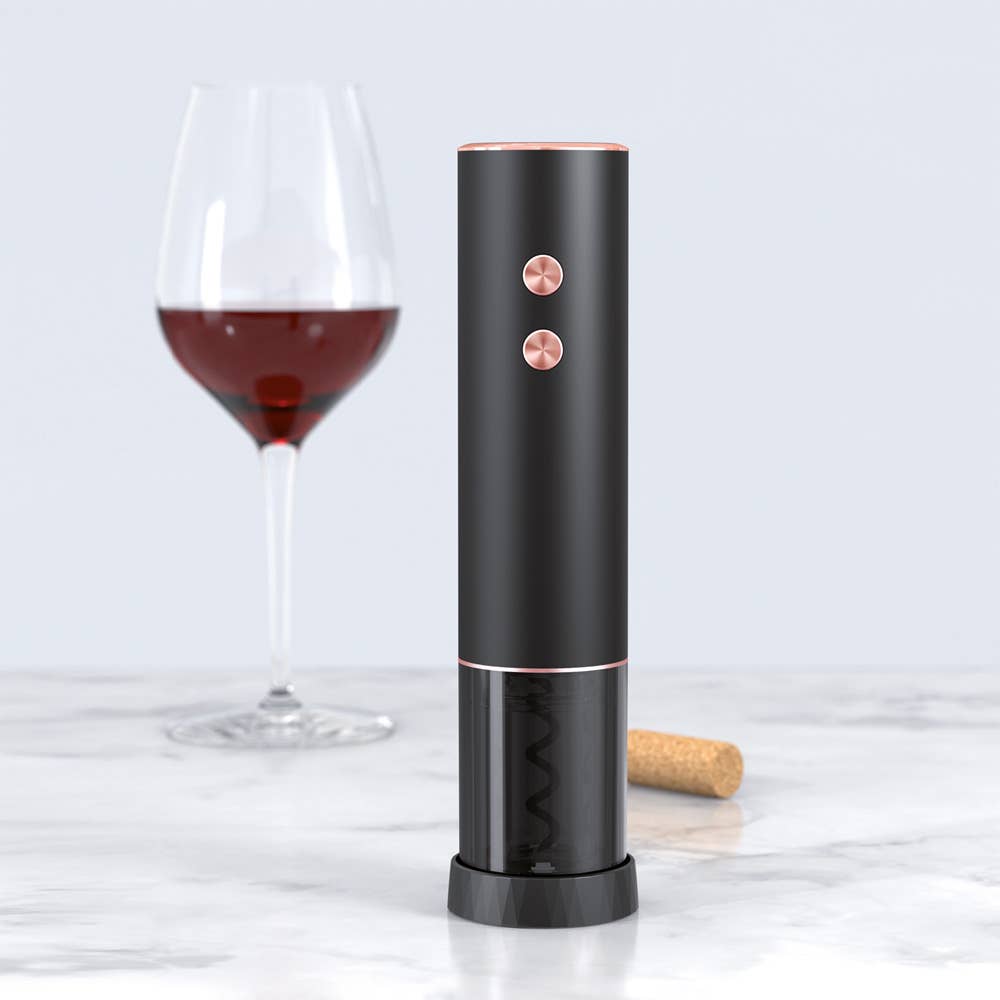Black electric wine opener with a glass of red wine and cork on a light gray background