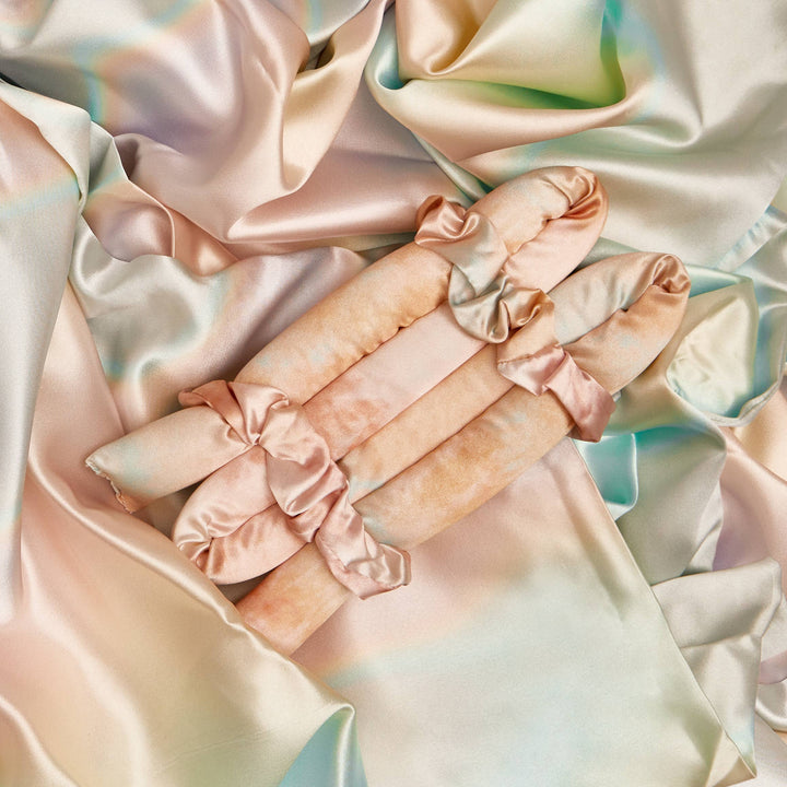 Silky satin fabric with pastel colors on a soft focus background