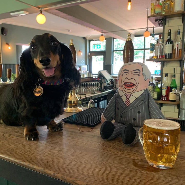 Dog sitting at a bar with a cartoon character and a glass of beer