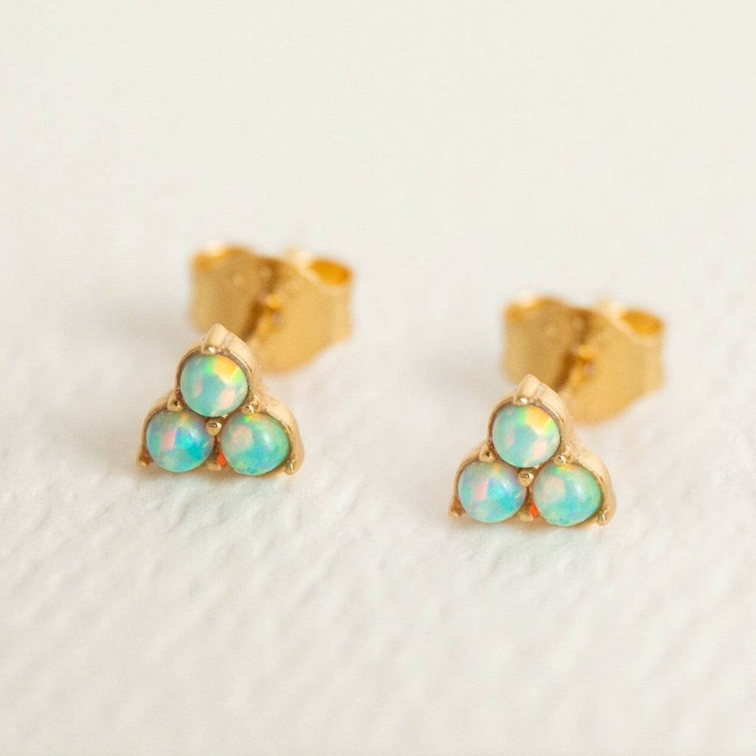A pair of gold vermeil stud earrings with three yellow opal stones set in a triangular formation.