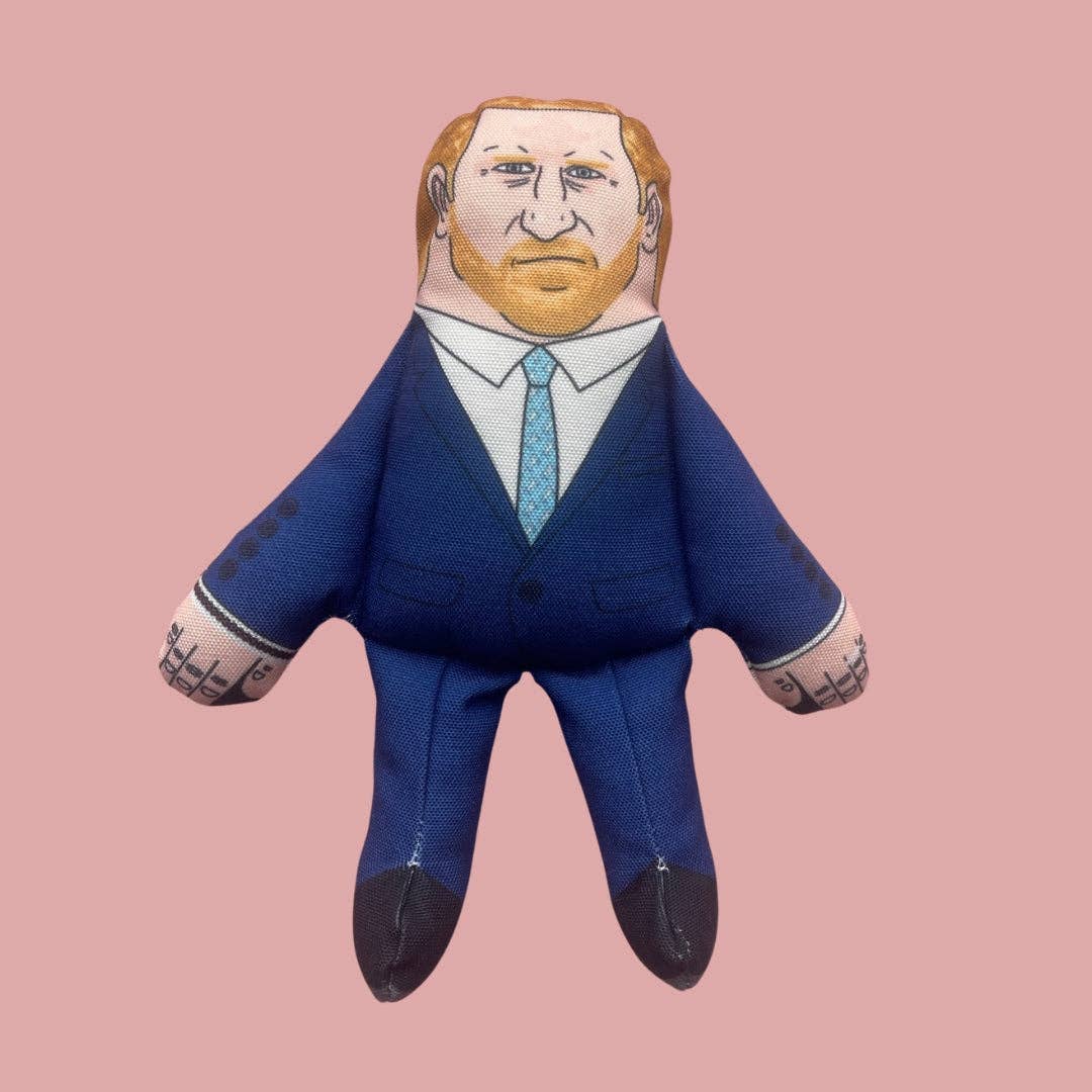 Stuffed toy resembling a person in a blue suit with tattoos on a pink background