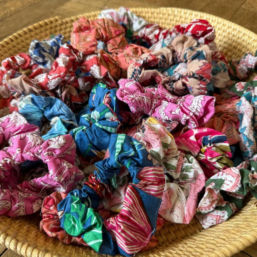 Colorful scrunchies on a woven surface