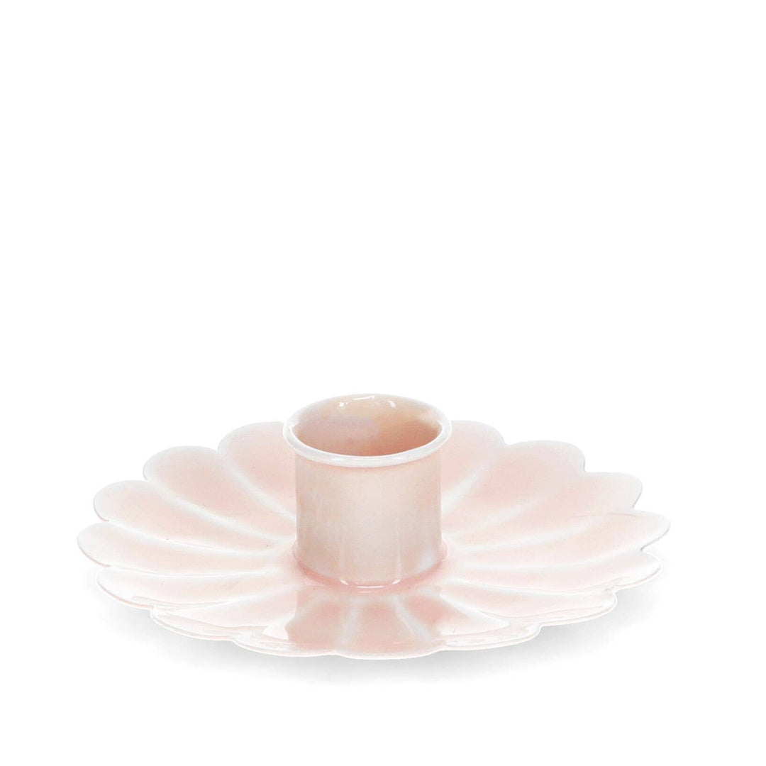 Pink ceramic plate with a central cylindrical holder on a white background