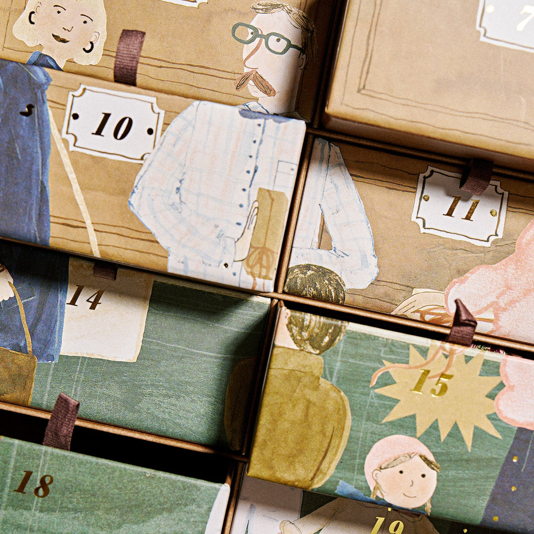 A close-up of the KKNEKKI 2026 Advent Calendar with multiple illustrated gift boxes arranged in a grid, each with a different vintage-style drawing of people and numbers from 6 to 19. The boxes are tan and green with small brown ribbon closures.
