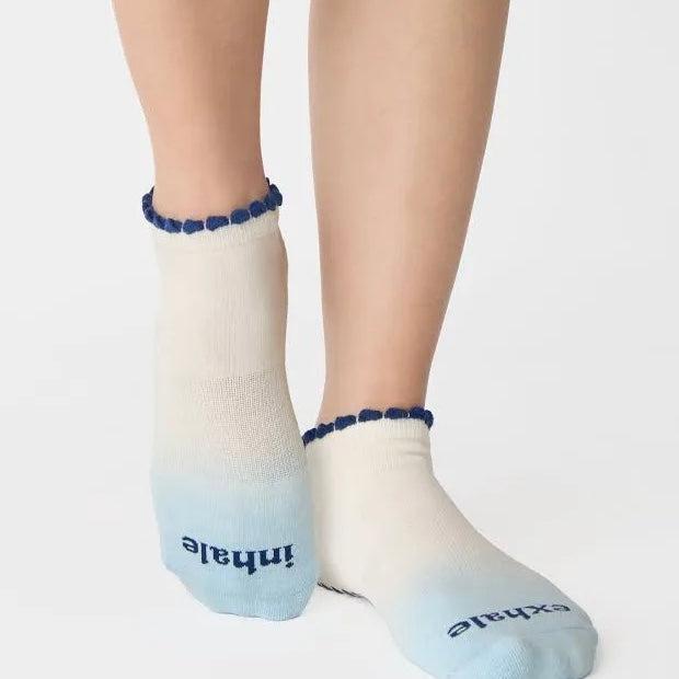 White ankle socks with blue accents and text on a white background