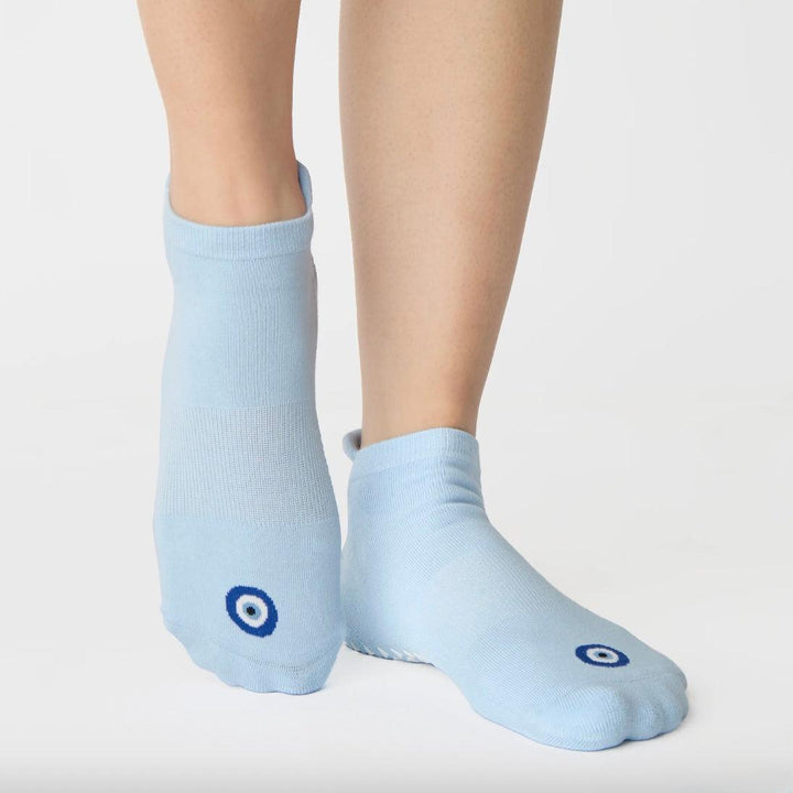 Light blue socks with a small blue circle design on a white background