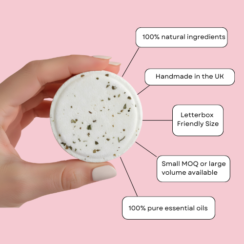 Hand holding a white product with text on a pink background