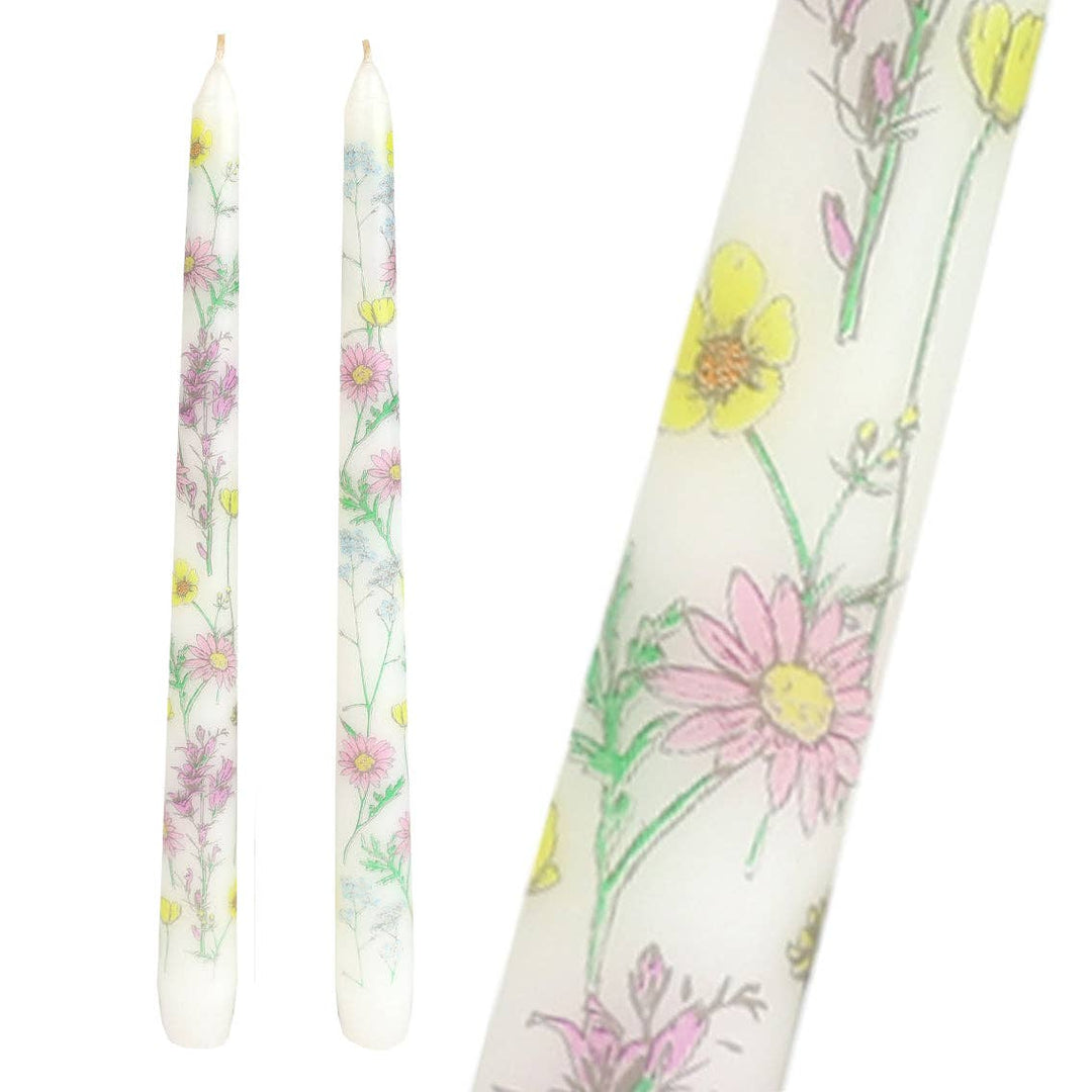 Floral-patterned candles on a white background
