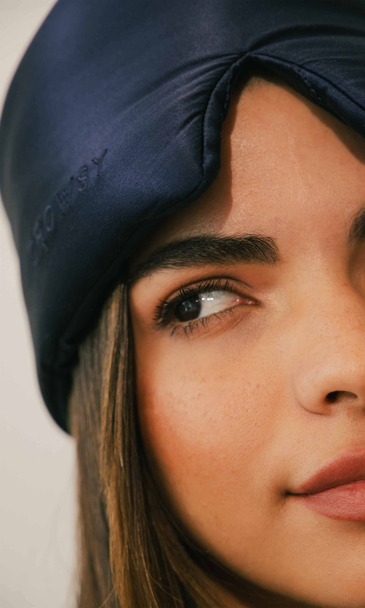 Close-up of a person wearing a navy blue headscarf with 'Chouch' branding.